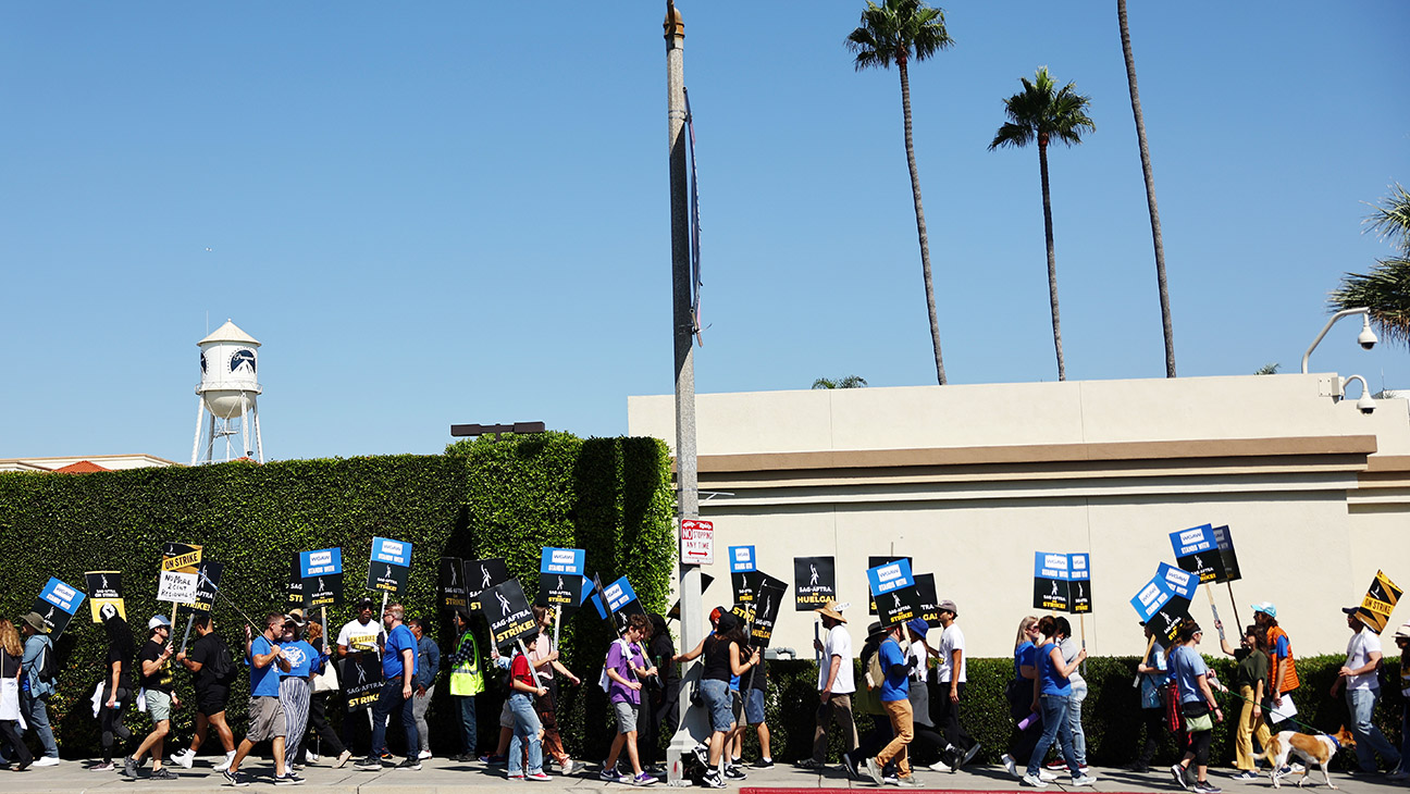 Striking SAG-AFTRA members picket as WGA (Writers Guild of America) members march in solidarity outside Paramount Studios on October 02, 2023 in Los Angeles, California.